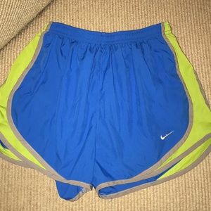 Blue nike shorts with lime green and grey trim